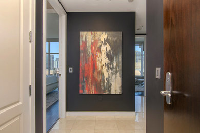 Photo of a mid-sized contemporary hallway in San Diego with black walls, ceramic floors and beige floor.