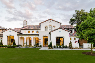 Photo of a mediterranean split-level stucco beige exterior in Dallas with a gable roof.