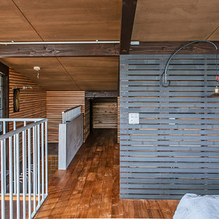 Esempio di una camera da letto etnica con pareti nere, parquet scuro e nessun camino