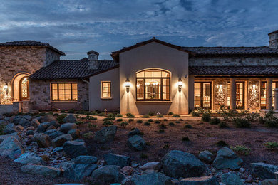 Inspiration for a huge timeless beige one-story stucco exterior home remodel in San Diego with a hip roof