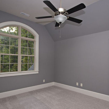Bedroom with white wood baseboards and lilac walls
