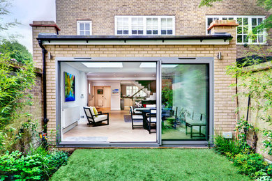 Inspiration for a large and beige contemporary bungalow house exterior in London.