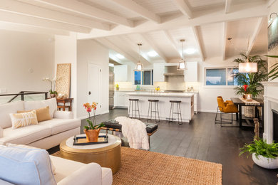 Small transitional dark wood floor open concept kitchen photo in Los Angeles with a farmhouse sink, shaker cabinets, white cabinets, marble countertops, gray backsplash, stone slab backsplash, stainless steel appliances and an island