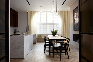 Design ideas for a contemporary kitchen in London with light hardwood flooring and grey floors.
