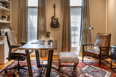 Home office - large transitional freestanding desk light wood floor and brown floor home office idea in DC Metro with beige walls