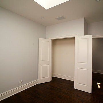 Minimalist Bedroom with Skylight and Double-Door Closet