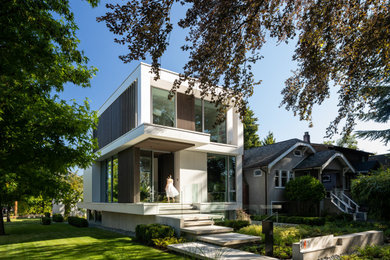 Small contemporary three-story mixed siding exterior home idea in Vancouver