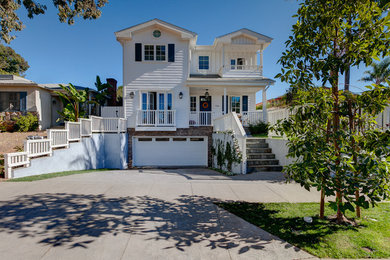 Large traditional three-storey white exterior in Los Angeles with wood siding.