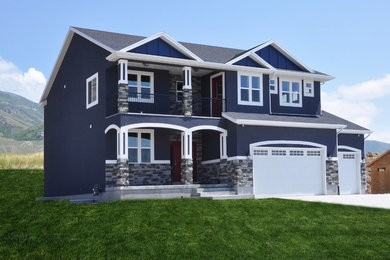 Inspiration for a large craftsman blue two-story stucco exterior home remodel in Salt Lake City with a shingle roof