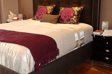 Inspiration for a mid-sized contemporary master medium tone wood floor and brown floor bedroom remodel in New York with beige walls and no fireplace