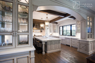 Inspiration for a huge mediterranean u-shaped dark wood floor and brown floor open concept kitchen remodel in Santa Barbara with a farmhouse sink, beaded inset cabinets, gray cabinets, marble countertops, white backsplash, marble backsplash, paneled appliances, an island and white countertops