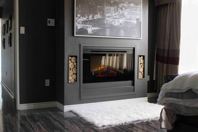 Inspiration for a large contemporary master bedroom in Toronto with grey walls and a plaster fireplace surround.