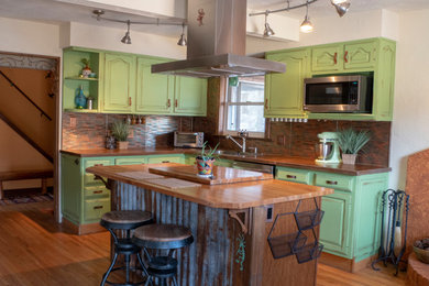 Example of a mid-sized southwest u-shaped medium tone wood floor eat-in kitchen design in Denver with an undermount sink, concrete countertops, stainless steel appliances and an island