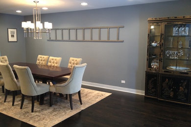 This is an example of a large eclectic separate dining room in Chicago with grey walls and dark hardwood floors.