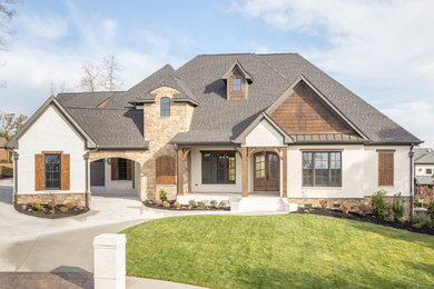 Large elegant white two-story brick gable roof photo in Other