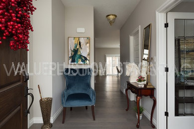 Hallway - large contemporary medium tone wood floor and gray floor hallway idea in Toronto with gray walls