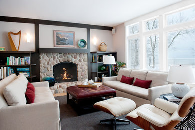 Example of a trendy enclosed light wood floor and brown floor family room design in Chicago with beige walls, a standard fireplace, a stone fireplace and no tv