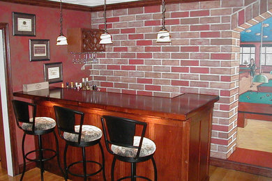 Inspiration for a small timeless galley medium tone wood floor and brown floor wet bar remodel in Boston with medium tone wood cabinets and brown countertops