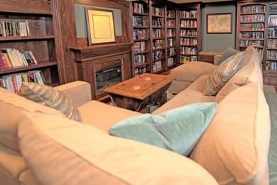 Basement - traditional underground medium tone wood floor basement idea in Chicago with green walls and a standard fireplace
