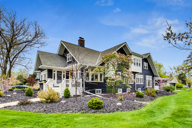 Example of a large transitional black two-story wood and clapboard exterior home design in Chicago
