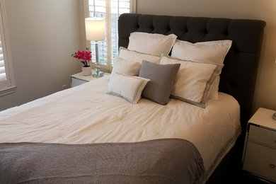 Bedroom - mid-sized transitional guest dark wood floor and brown floor bedroom idea in Orange County with gray walls and no fireplace