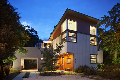 Photo of a large contemporary two-storey grey house exterior in Raleigh with mixed siding.