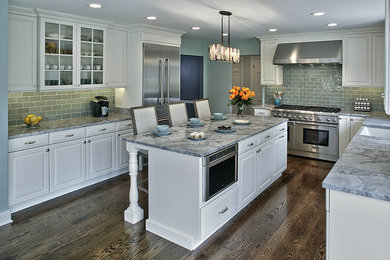 Eat-in kitchen - large transitional u-shaped dark wood floor eat-in kitchen idea in Chicago with a farmhouse sink, raised-panel cabinets, white cabinets, marble countertops, green backsplash, glass tile backsplash, stainless steel appliances and an island