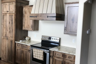 Inspiration for a large timeless dark wood floor and brown floor open concept kitchen remodel in Other with flat-panel cabinets, distressed cabinets, granite countertops and an island