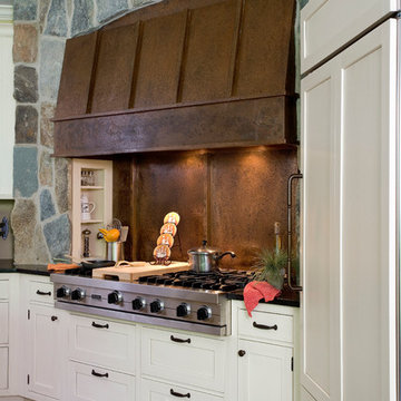 White Brookhaven Cabinet Kitchen with Stone Surround and Copper Hood