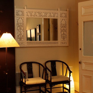 Photo of a small eclectic foyer in New York with beige walls, medium hardwood floors, a single front door and a white front door.
