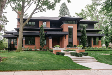 Example of a large transitional two-story brick house exterior design in Toronto