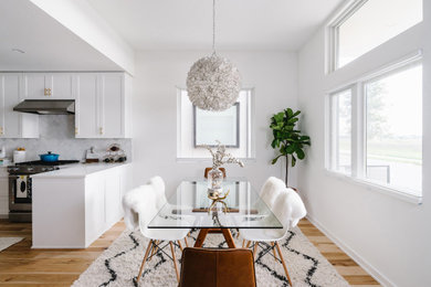 Example of a mid-sized danish light wood floor and beige floor kitchen/dining room combo design in San Francisco with white walls