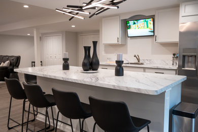 Large elegant galley vinyl floor eat-in kitchen photo in Detroit with an undermount sink, flat-panel cabinets, white cabinets, laminate countertops, stainless steel appliances, an island and white countertops