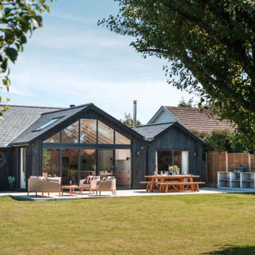 Black timber-clad house with garden terrace - bungalow extension, Rock, Cornwall