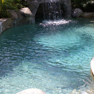 Lagoon style pool with grotto and custom stone work.
