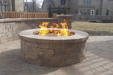 This is an example of a mid-sized full sun backyard brick landscaping in Kansas City.