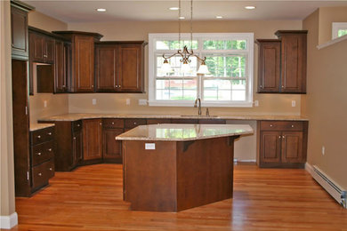 Large elegant single-wall medium tone wood floor open concept kitchen photo in Bridgeport with an undermount sink, light wood cabinets, green backsplash, an island, raised-panel cabinets, granite countertops and stainless steel appliances