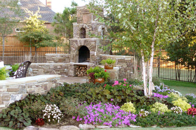 Inspiration for a large timeless backyard stone patio remodel in Oklahoma City with a fire pit