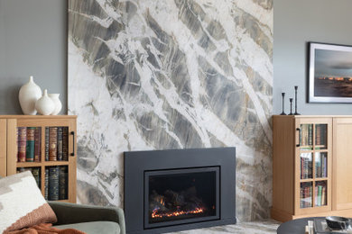 Living room - mid-sized transitional light wood floor living room idea in Seattle with gray walls, a standard fireplace, a stone fireplace and a wall-mounted tv