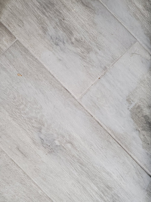 grout left tile discolored and can't get it off