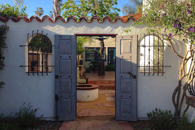Example of a tuscan house exterior design in San Diego with a tile roof
