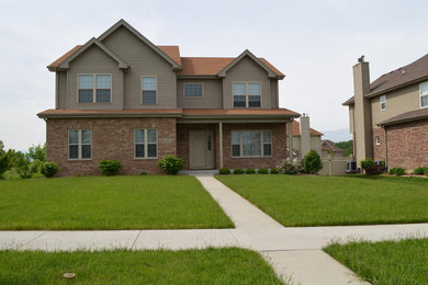 Mid-sized transitional beige two-story mixed siding gable roof photo in Other