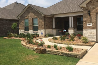 Inspiration for a large traditional full sun front yard concrete paver landscaping in Houston.