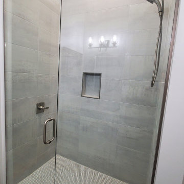 Elegant Shower done with 12x24 tiles and penny rounds.
