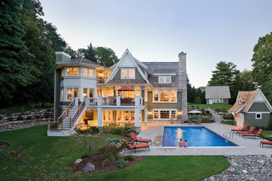 Inspiration for a coastal brown three-story wood exterior home remodel in Vancouver with a shingle roof