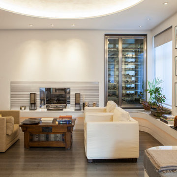 Lounge. Double aspect fireplace & bespoke wine storage