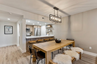 Example of a mid-sized minimalist vinyl floor and brown floor dining room design in Salt Lake City with white walls