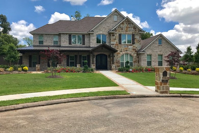 Example of a large transitional multicolored two-story mixed siding exterior home design in Houston with a mixed material roof