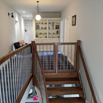 Matching stair gates in Black Walnut with stainless steel spindles