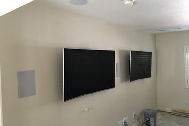 Example of a mid-sized minimalist open concept carpeted home theater design in Phoenix with beige walls and a wall-mounted tv
